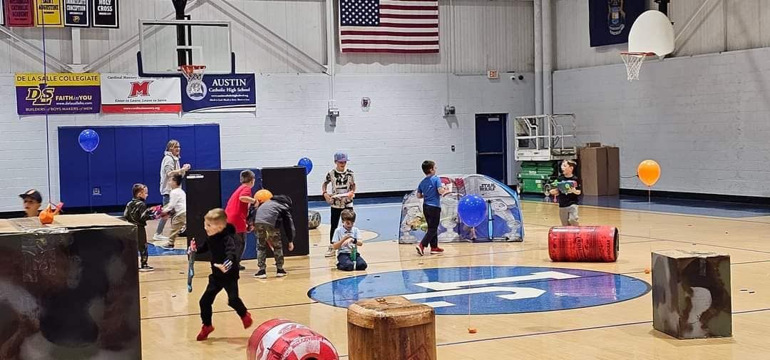 A group of children playing in the school gymnasium.