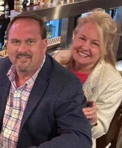 A man and a woman are sitting at a table in a restaurant.
