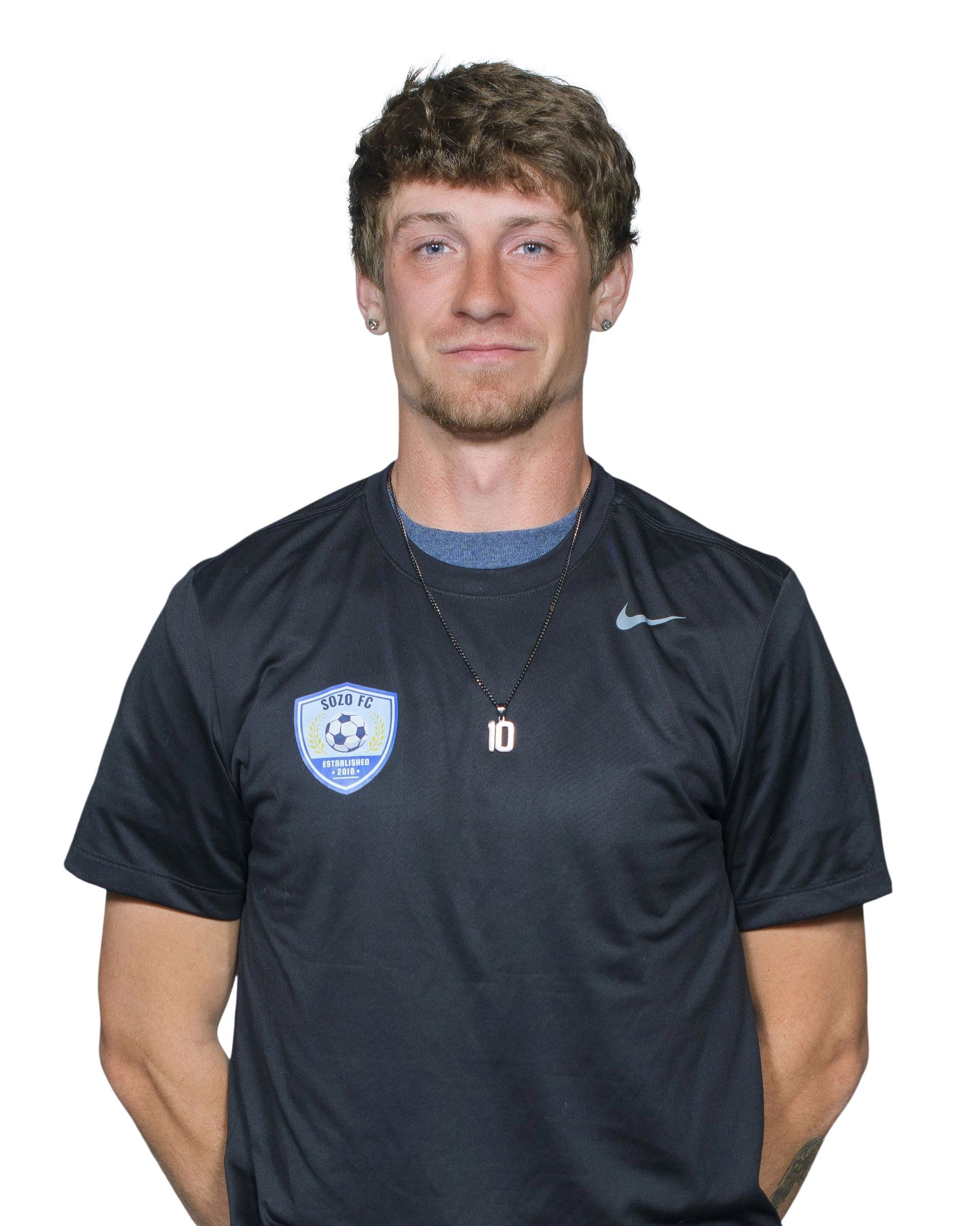 Portrait of a person in a black sports jersey standing against a white background