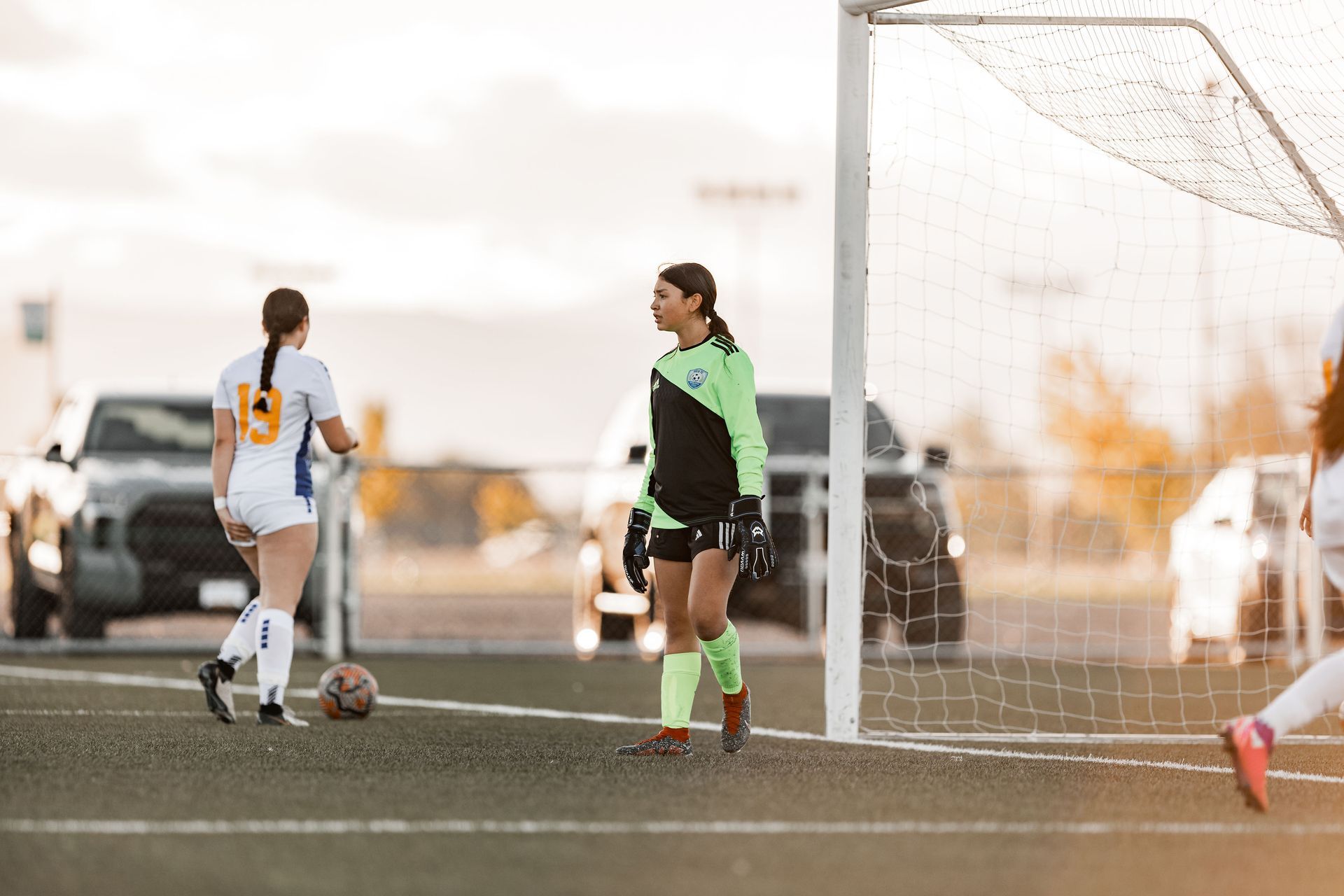 A group of women are playing soccer on a field.