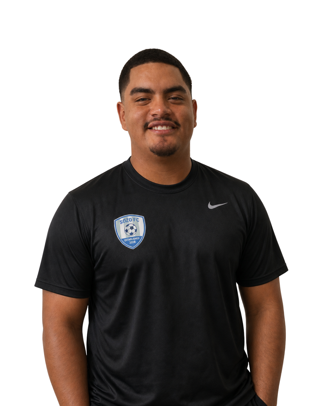 Smiling man in a black Nike T-shirt with a shield logo, standing against a white background