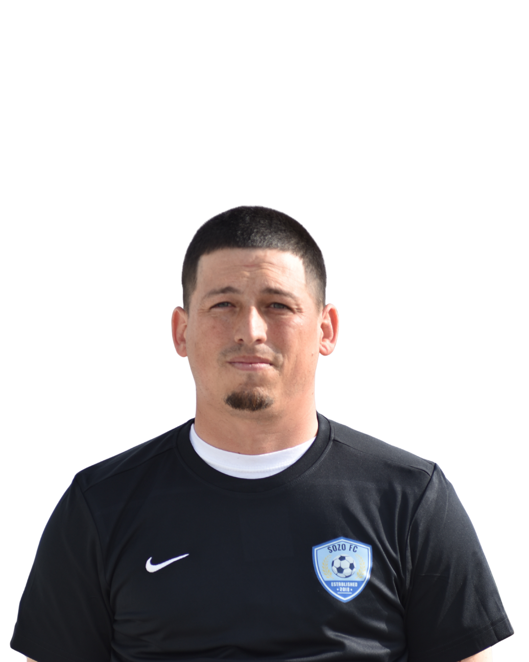 Man wearing a black Nike sports jersey with a team crest, standing against a plain white background