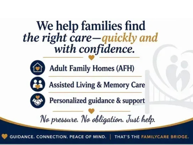 Caregiver smiling and leaning toward an elderly man in a bright nursing home lounge