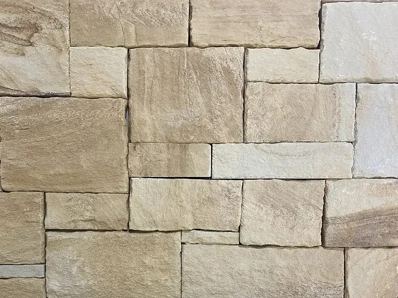 Tan and light beige stone wall with a random pattern — Premier Bricks, Blocks & Pavers In Heatherbrae, NSW