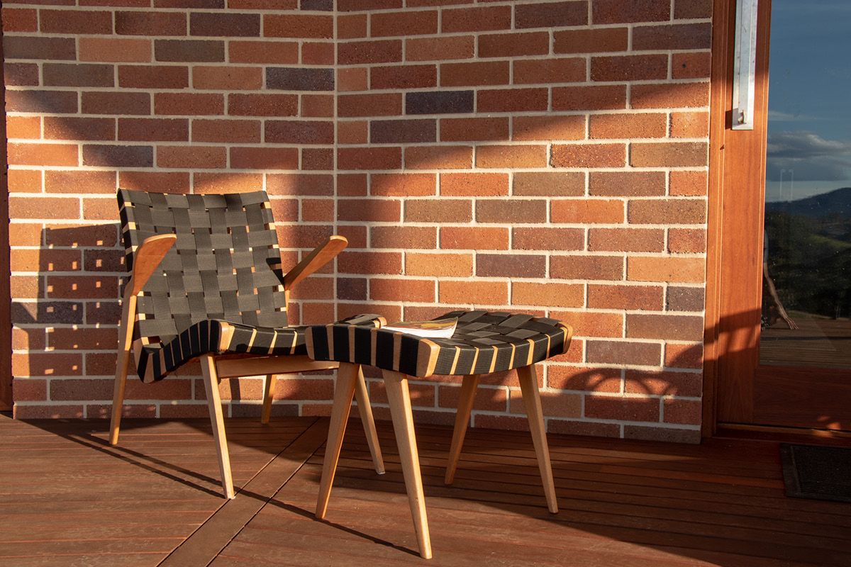 A living room with a brick wall and a fireplace — Premier Bricks, Blocks & Pavers In Heatherbrae, NSW