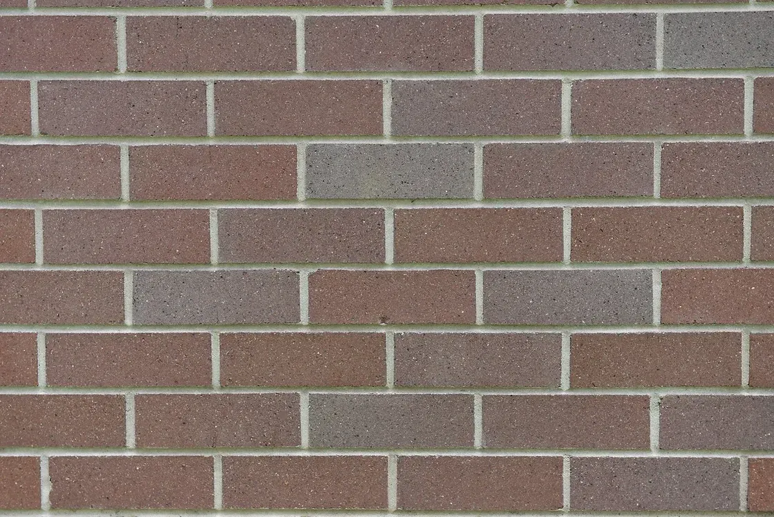 Brick wall with red and gray bricks, white mortar — Premier Bricks, Blocks & Pavers In Heatherbrae, NSW