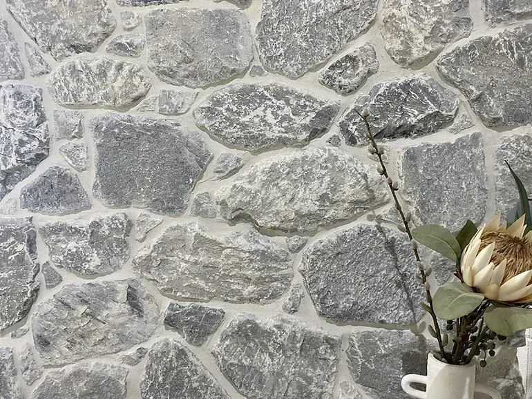 Stone wall with grey rocks and white mortar — Premier Bricks, Blocks & Pavers In Heatherbrae, NSW