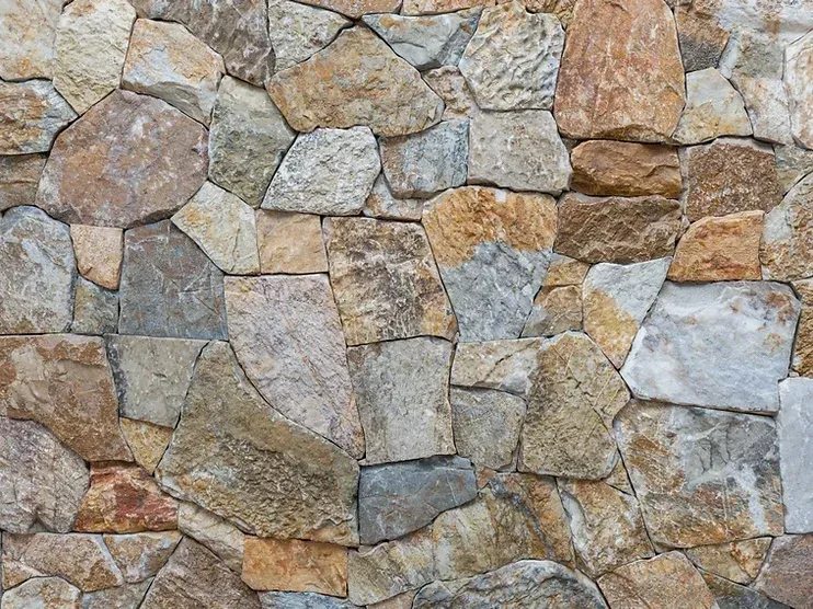 Stone wall composed of irregularly shaped, multi-colored rocks — Premier Bricks, Blocks & Pavers In Heatherbrae, NSW