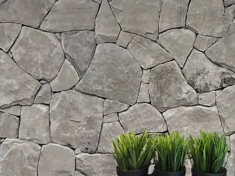 Stone wall with three small potted green plants in front — Premier Bricks, Blocks & Pavers In Heatherbrae, NSW