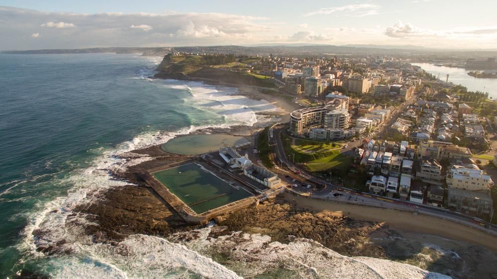 An Aerial View Of A City Next To A Body Of Water — Premier Bricks, Blocks & Pavers In Newcastle, NSW