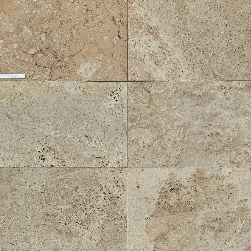 Four beige stone tiles with varied textures and dark speckling — Premier Bricks, Blocks & Pavers In Heatherbrae, NSW