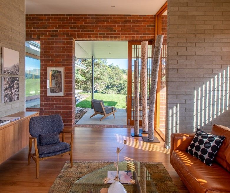 A Close Up Of A Pile Of Brown Bricks On A Wooden Floor — Premier Bricks, Blocks & Pavers In Heatherbrae, NSW