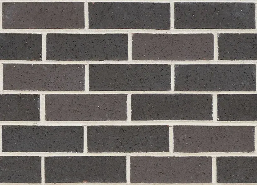 Dark gray and charcoal brick wall with white mortar — Premier Bricks, Blocks & Pavers In Heatherbrae, NSW