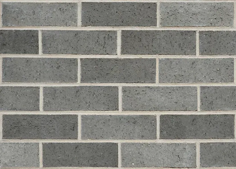 Gray brick wall with alternating brick placement, white mortar — Premier Bricks, Blocks & Pavers In Heatherbrae, NSW