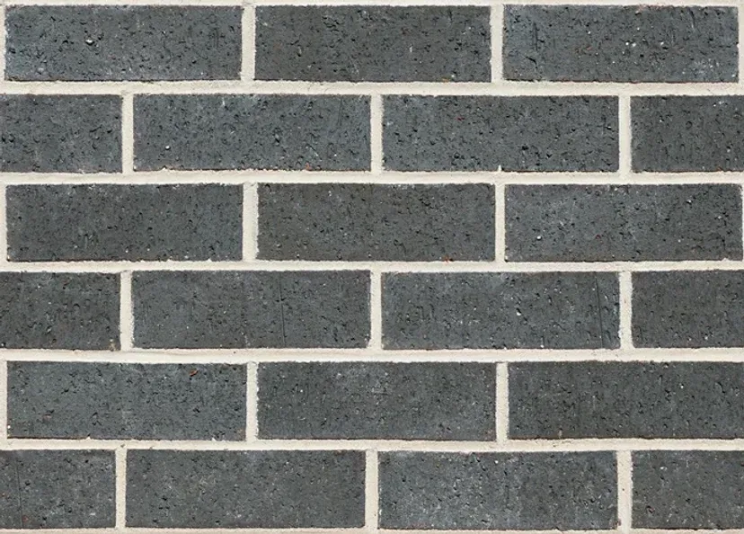 Dark gray brick wall with white mortar — Premier Bricks, Blocks & Pavers In Heatherbrae, NSW