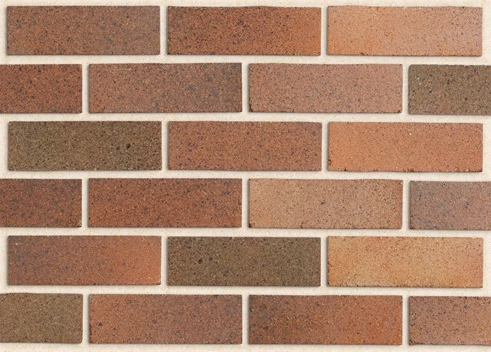 Brick wall with varying shades of red, brown, and tan bricks — Premier Bricks, Blocks & Pavers In Heatherbrae, NSW