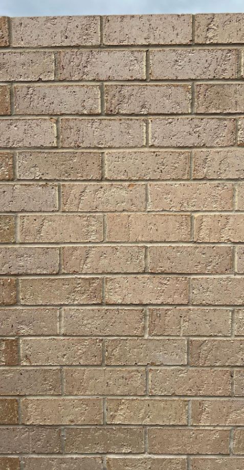 A Close Up Of A Brick Wall With A Blue Sky In The Background — Premier Bricks, Blocks & Pavers In Cessnock, NSW