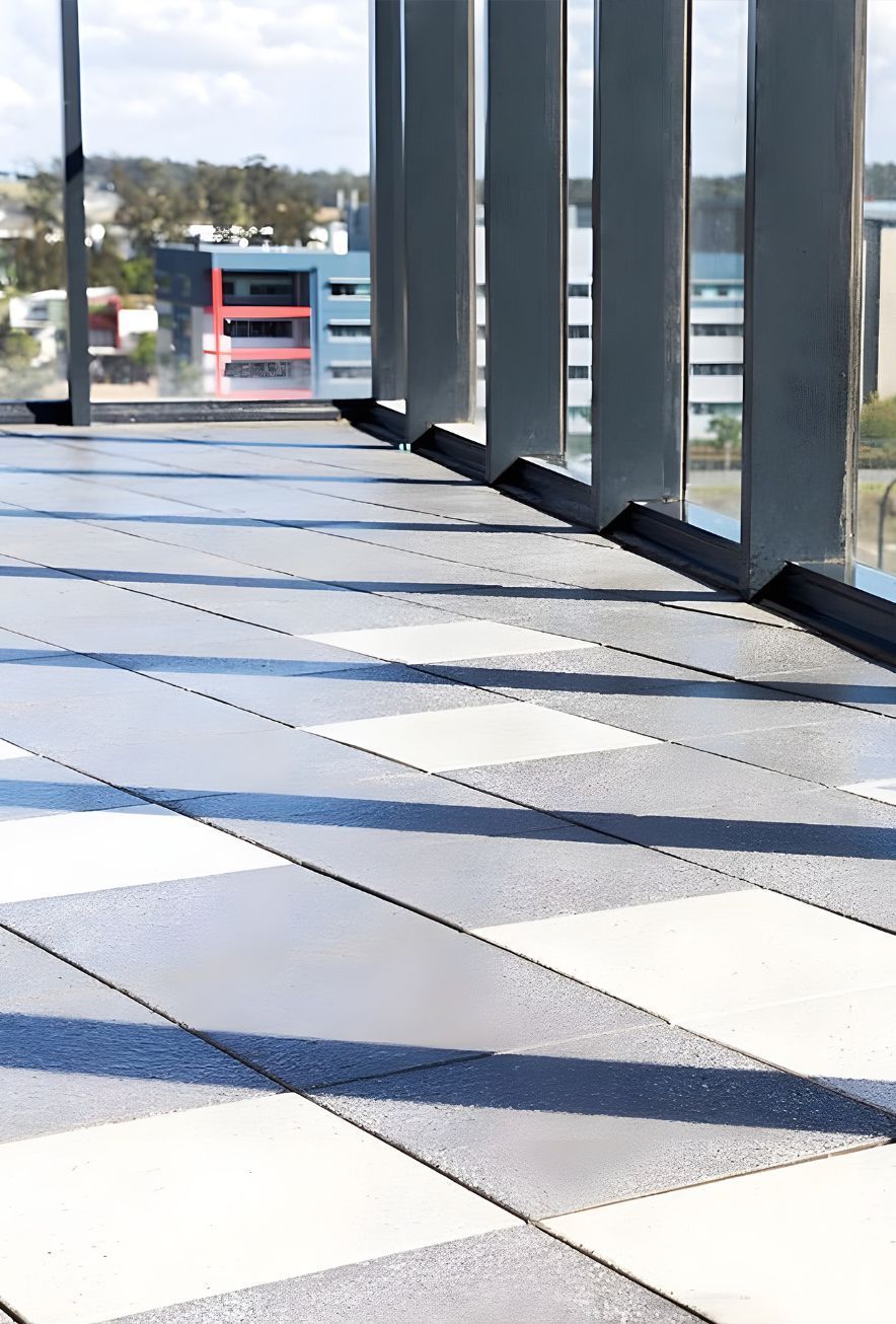 A Hallway With A Lot Of Windows And A Checkered Floor — Premier Bricks, Blocks & Pavers In Newcastle, NSW