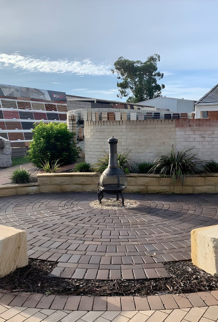 A Brick Patio With A Fire Pit In The Middle Of It — Premier Bricks, Blocks & Pavers In Lochinvar, NSW