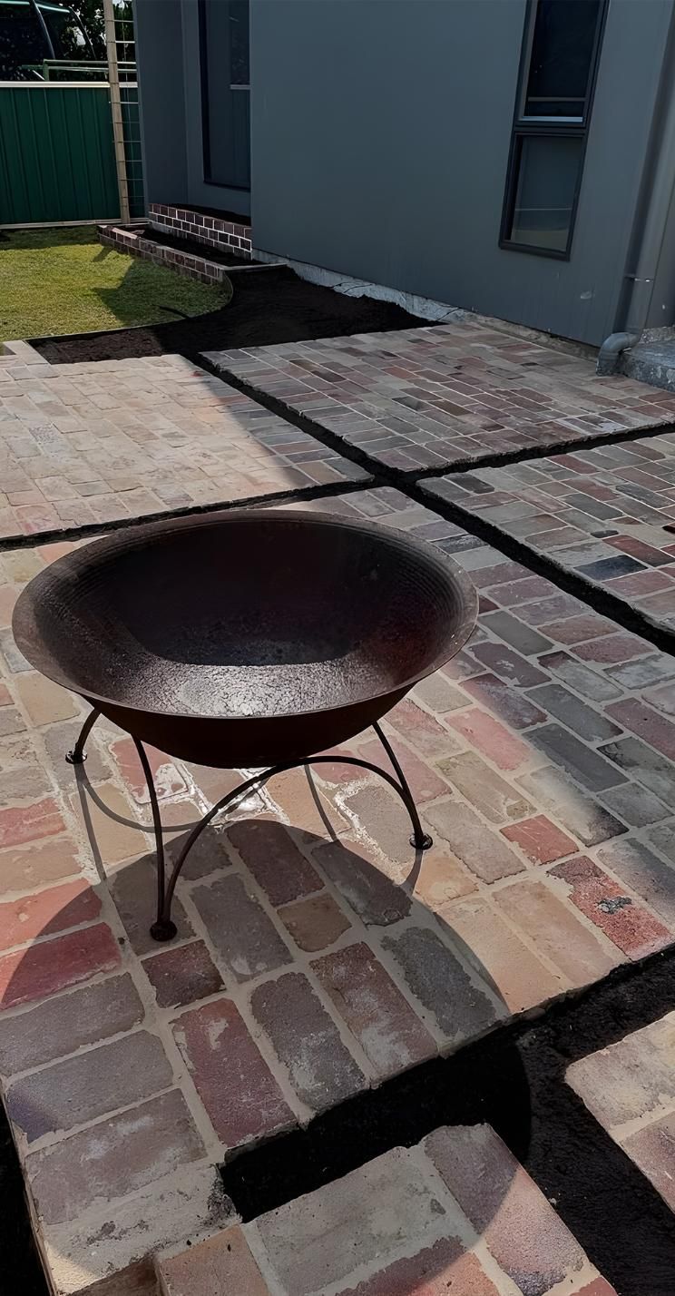 A Fire Pit Is Sitting On Top Of A Brick Patio — Premier Bricks, Blocks & Pavers In Heatherbrae, NSW