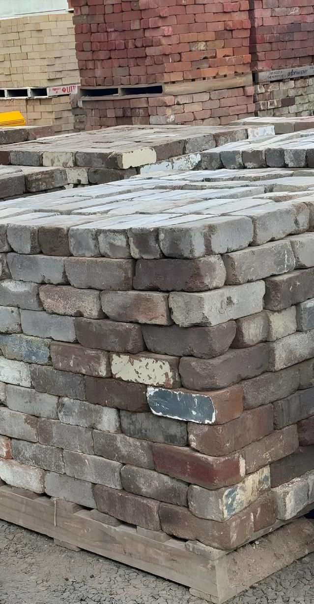 A Pile Of Bricks Stacked On Top Of Each Other On A Wooden Pallet — Premier Bricks, Blocks & Pavers In Cessnock, NSW