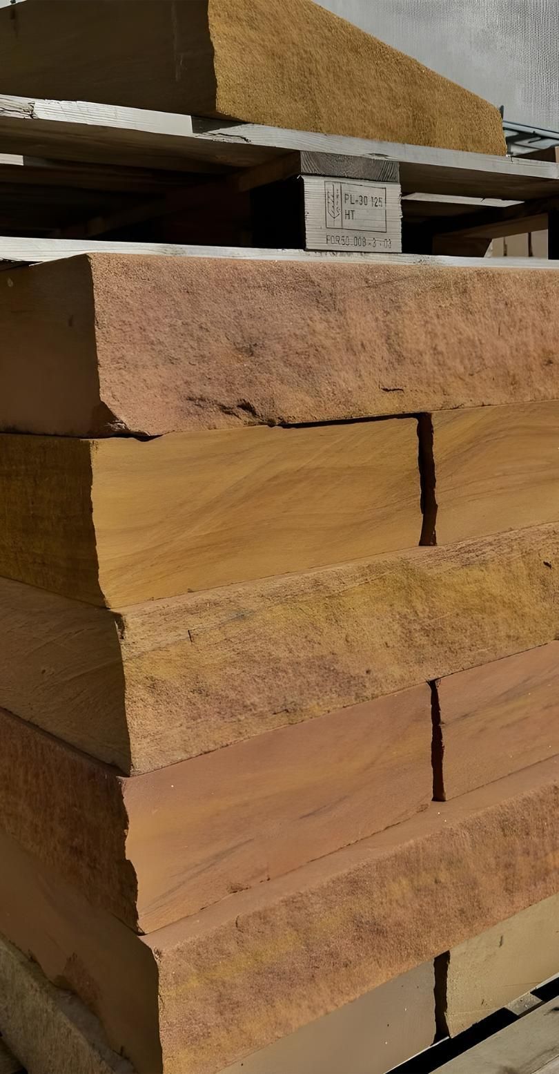 A Stack Of Wooden Blocks Sitting On Top Of Each Other On A Wooden Pallet — Premier Bricks, Blocks & Pavers In Maitland, NSW
