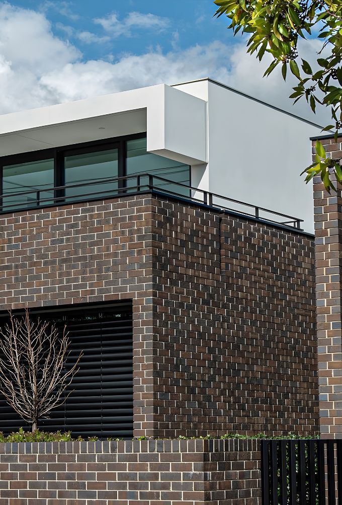A Living Room With A Brick Wall And A Fireplace — Premier Bricks, Blocks & Pavers In Newcastle, NSW