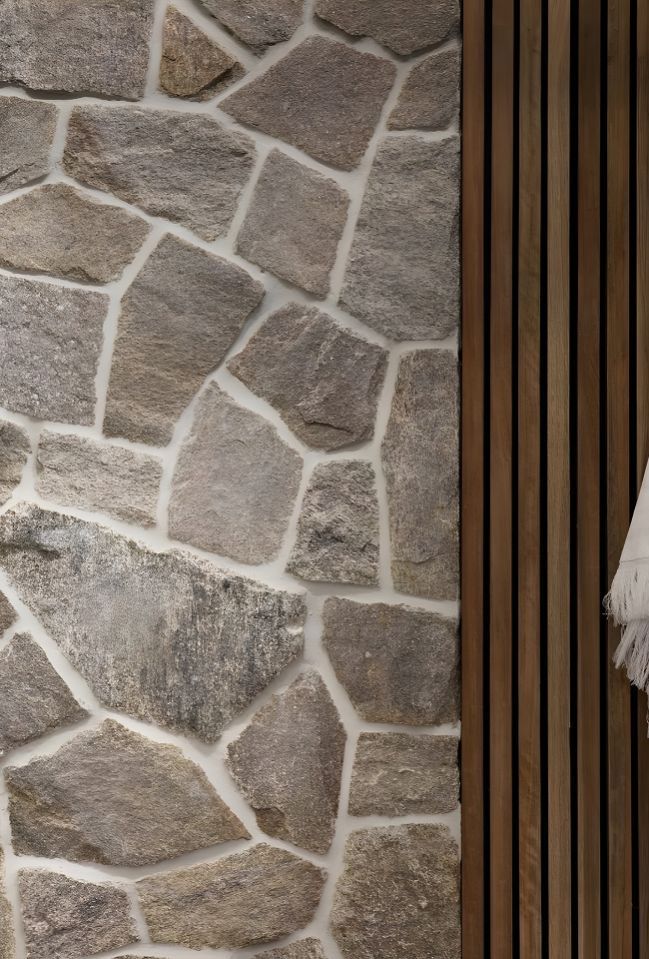 A Stone Wall With A Wooden Floor In A Hallway — Premier Bricks, Blocks & Pavers In Newcastle, NSW