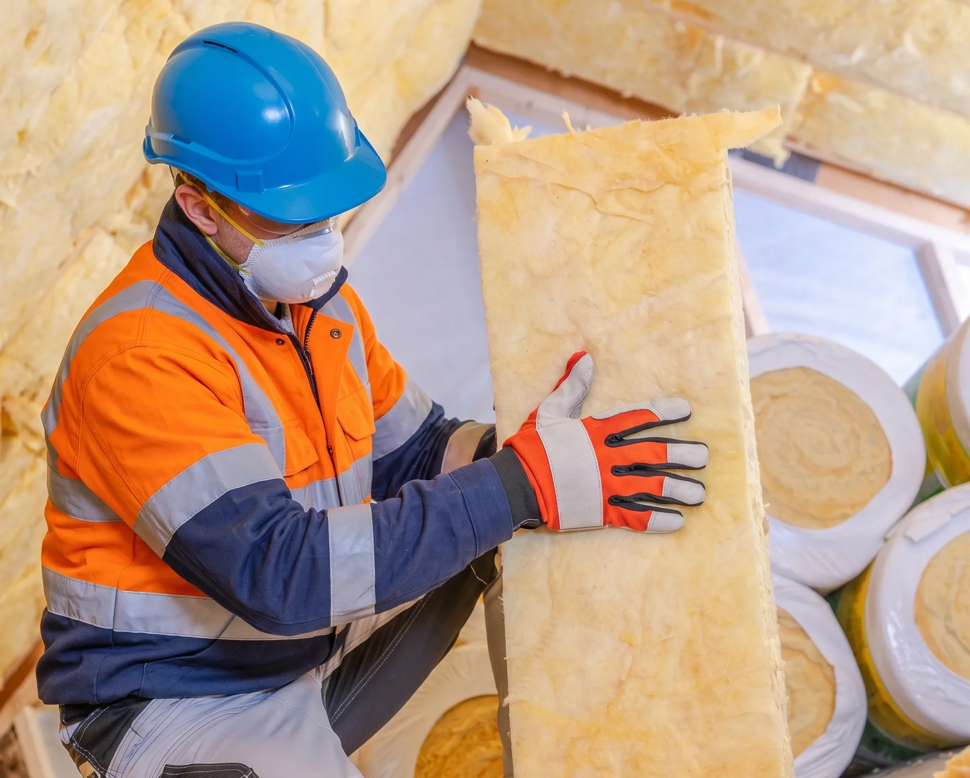 The Elite Insulation Services team is working on installing batts.