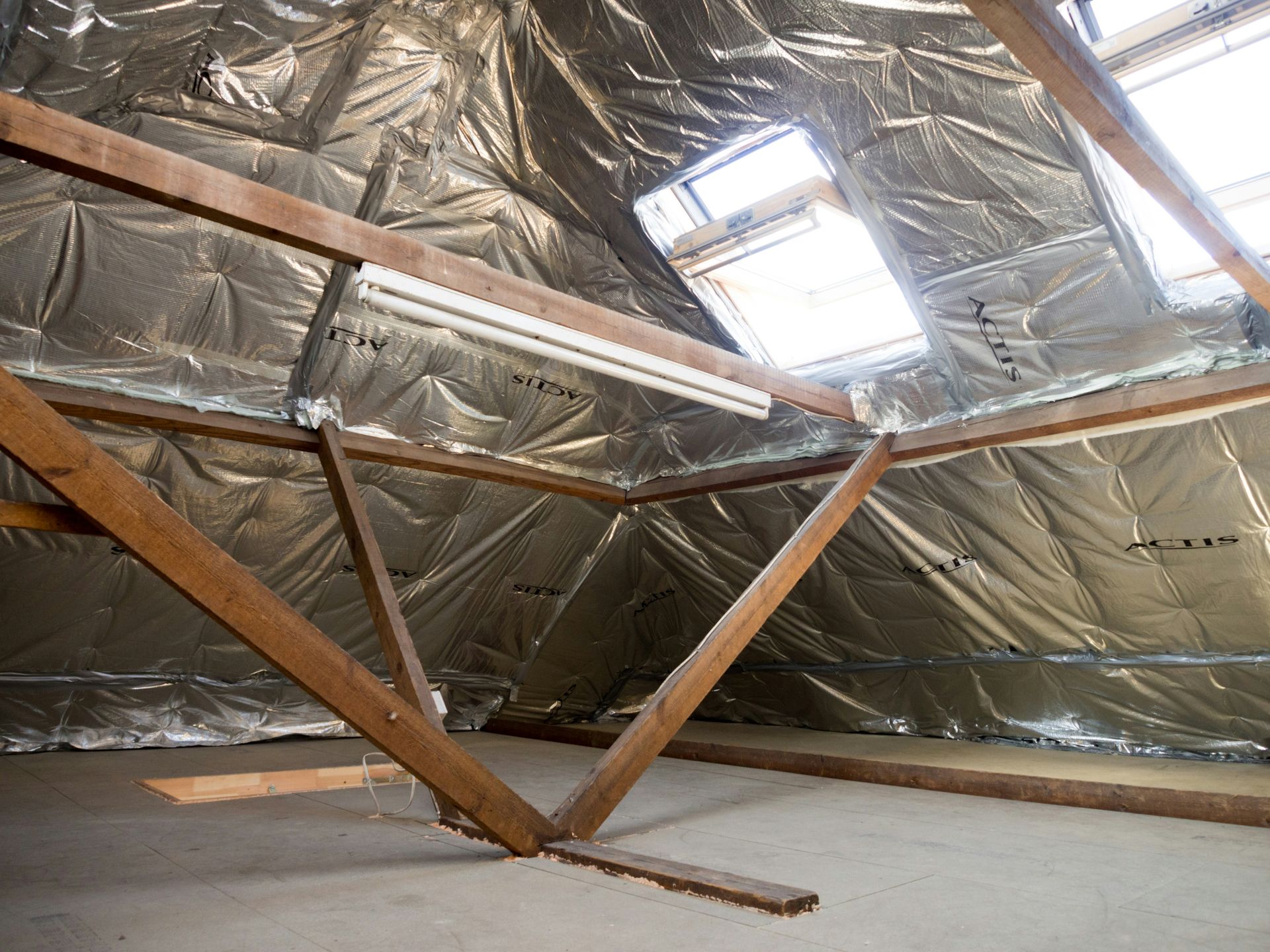 Roof space with exposed timber trusses and skylight openings