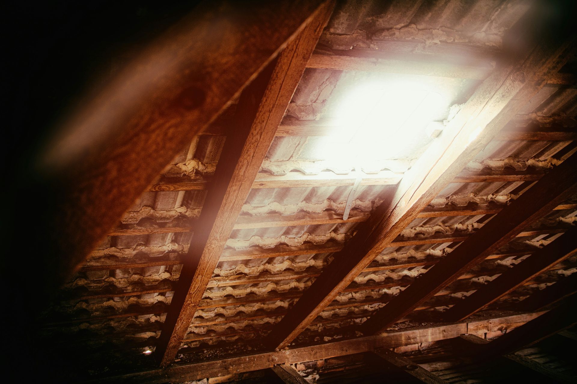 Sunlight entering a dark roof cavity through a gap in the roofing