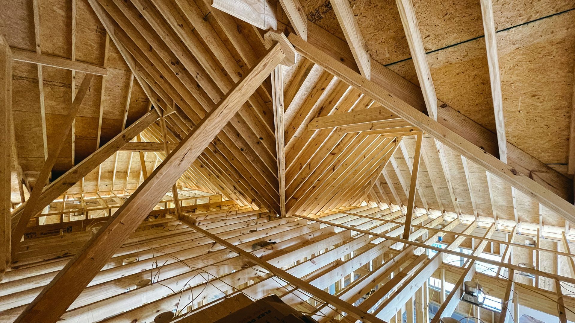 Timber roof framing with insulation installed between the rafters