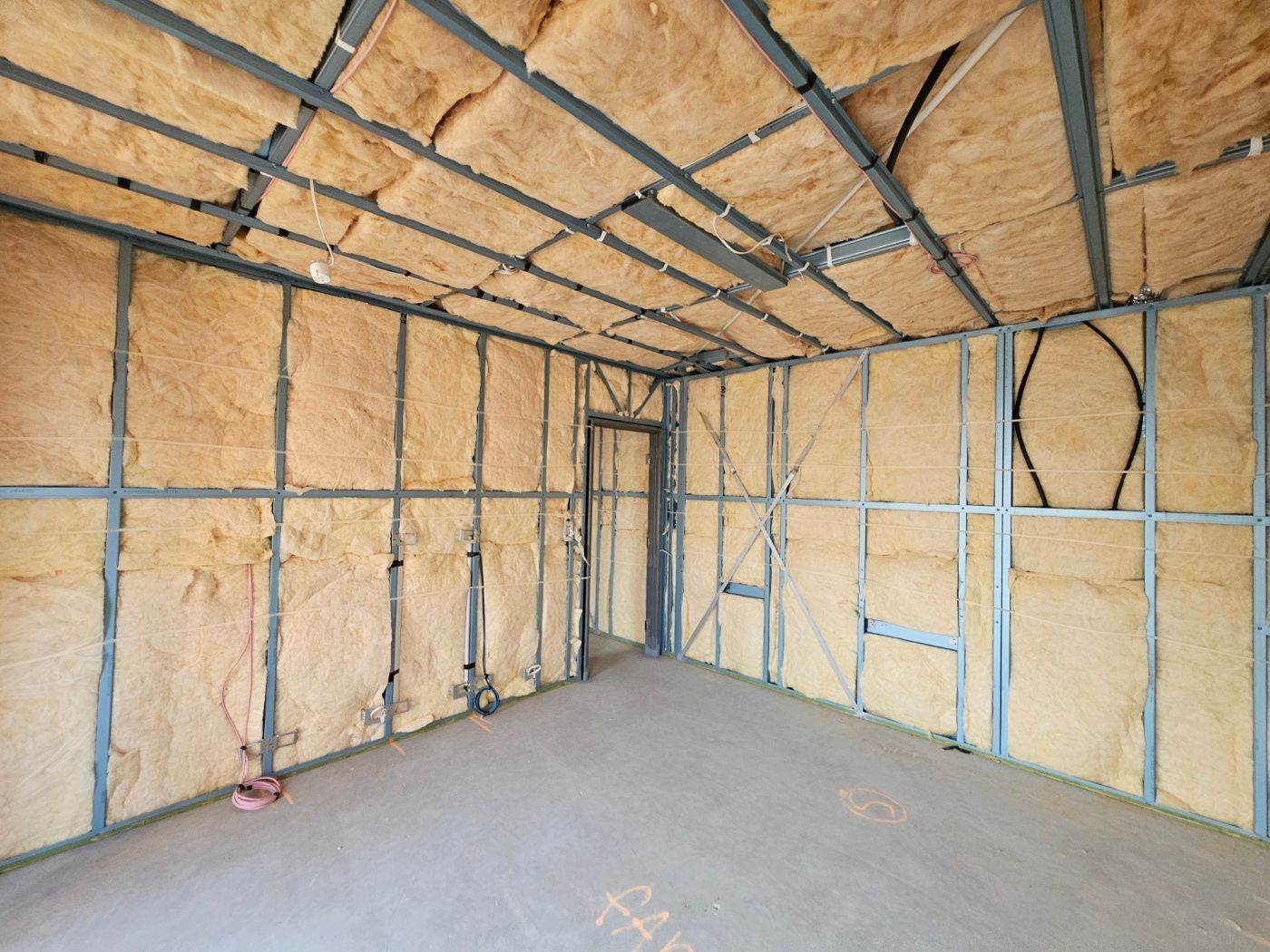 Glasswool insulation batts installed between timber wall studs during construction