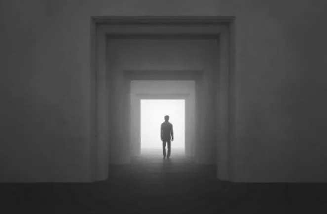 Man Walking through the Huge Doors
