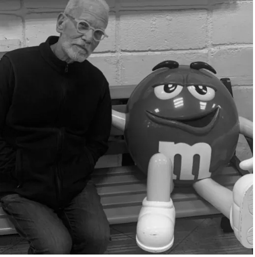 Man Beside a Huge M&M's Statue Man Beside a Huge M&M's Statue