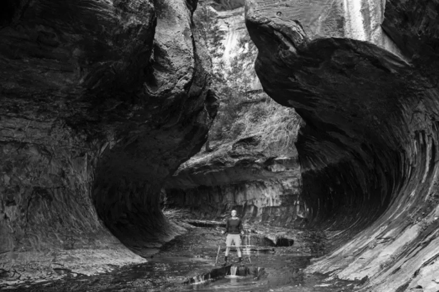 Man Stands in the middle of a Canyon Man Stands in the middle of a Canyon