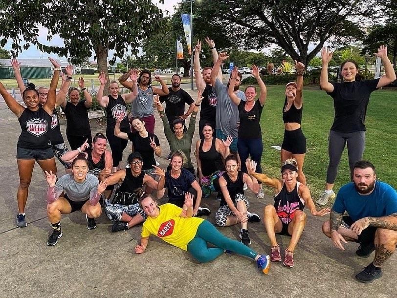 A Group Of People Are Posing For A Picture In A Park — Elev8ed Fitness In Currajong, QLD