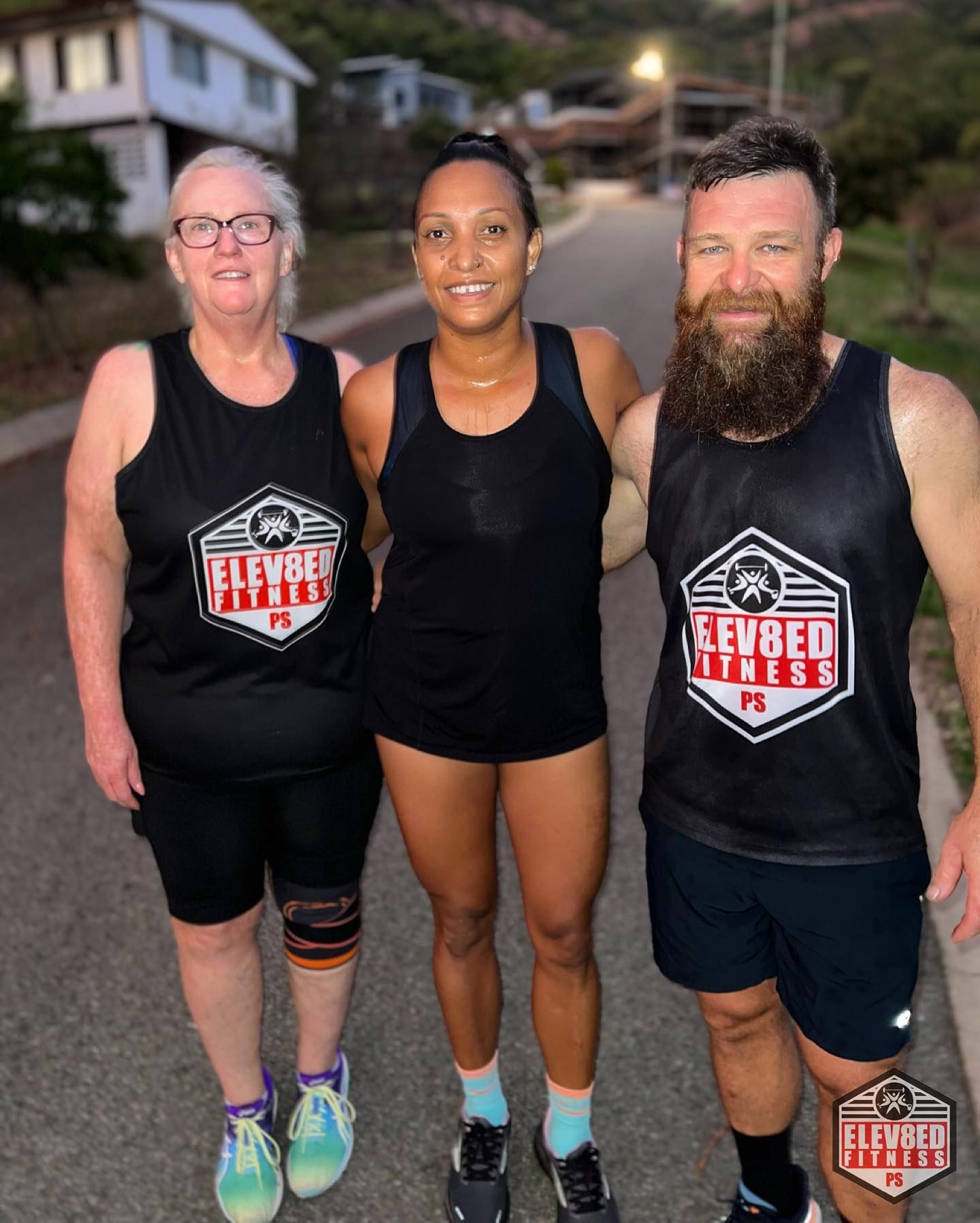 A Man And Two Women Are Standing Next To Each Other On A Street — Elev8ed Fitness In Currajong, QLD