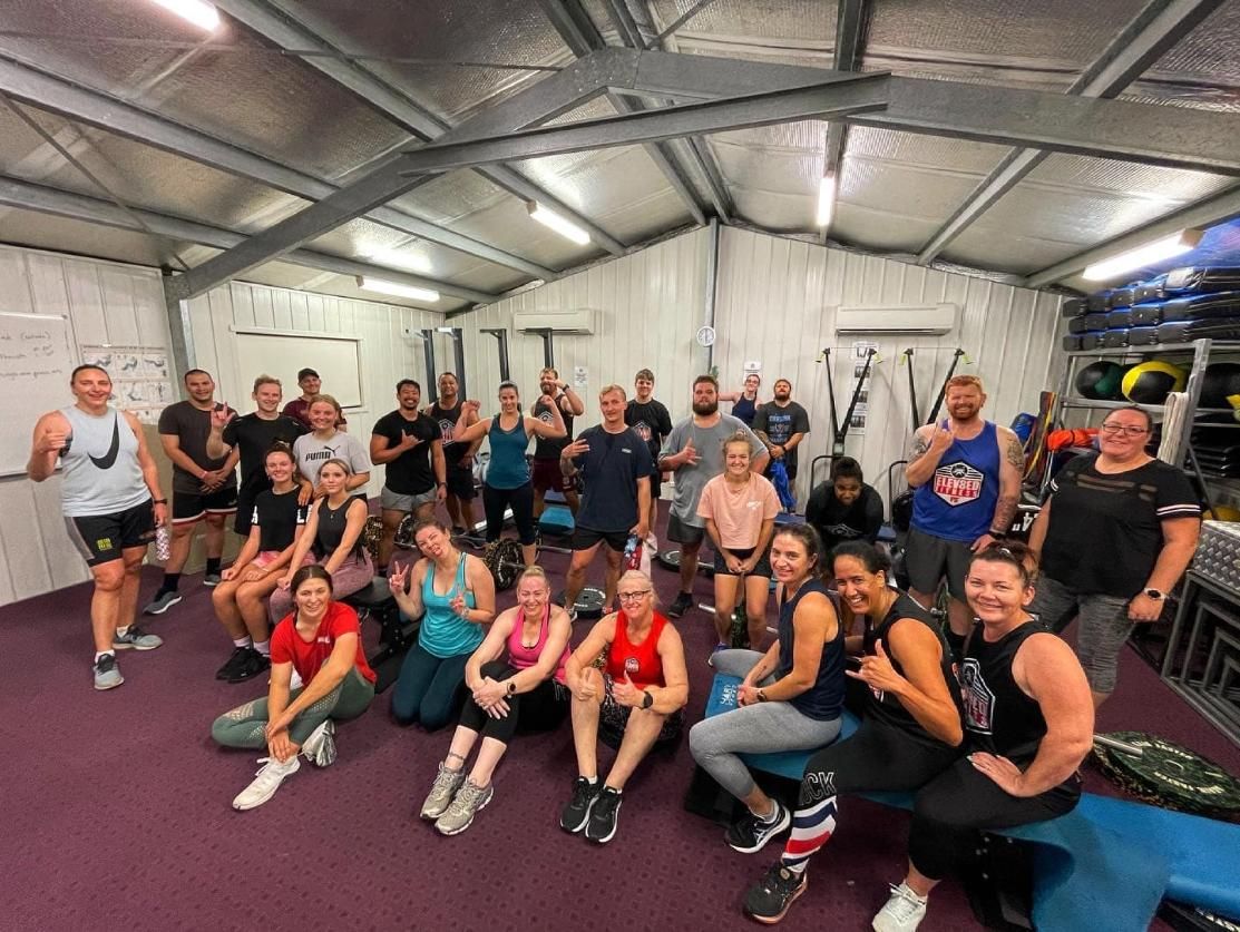A Group Of People Are Posing For A Picture In A Gym — Elev8ed Fitness In Currajong, QLD