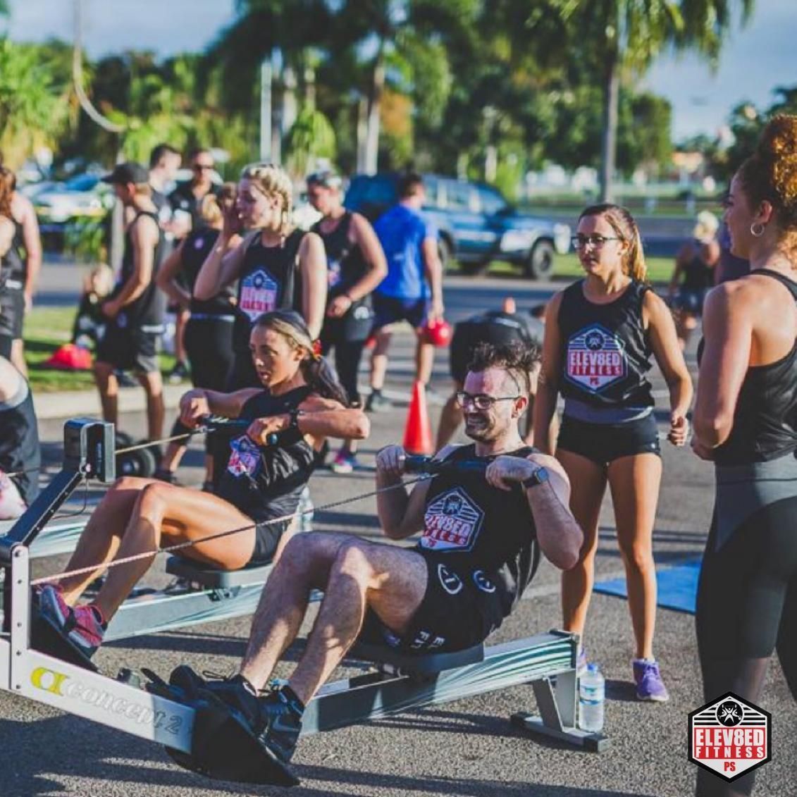 A Group Of People Are Doing Exercises On Rowing Machines — Elev8ed Fitness In Currajong, QLD