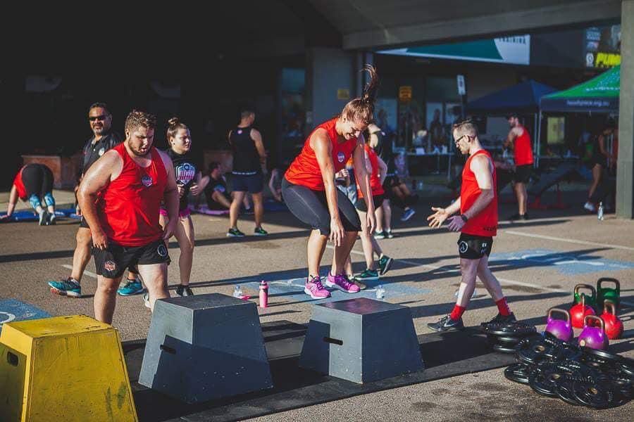 A Group Of People Are Doing Exercises In A Parking Lot — Elev8ed Fitness In Currajong, QLD