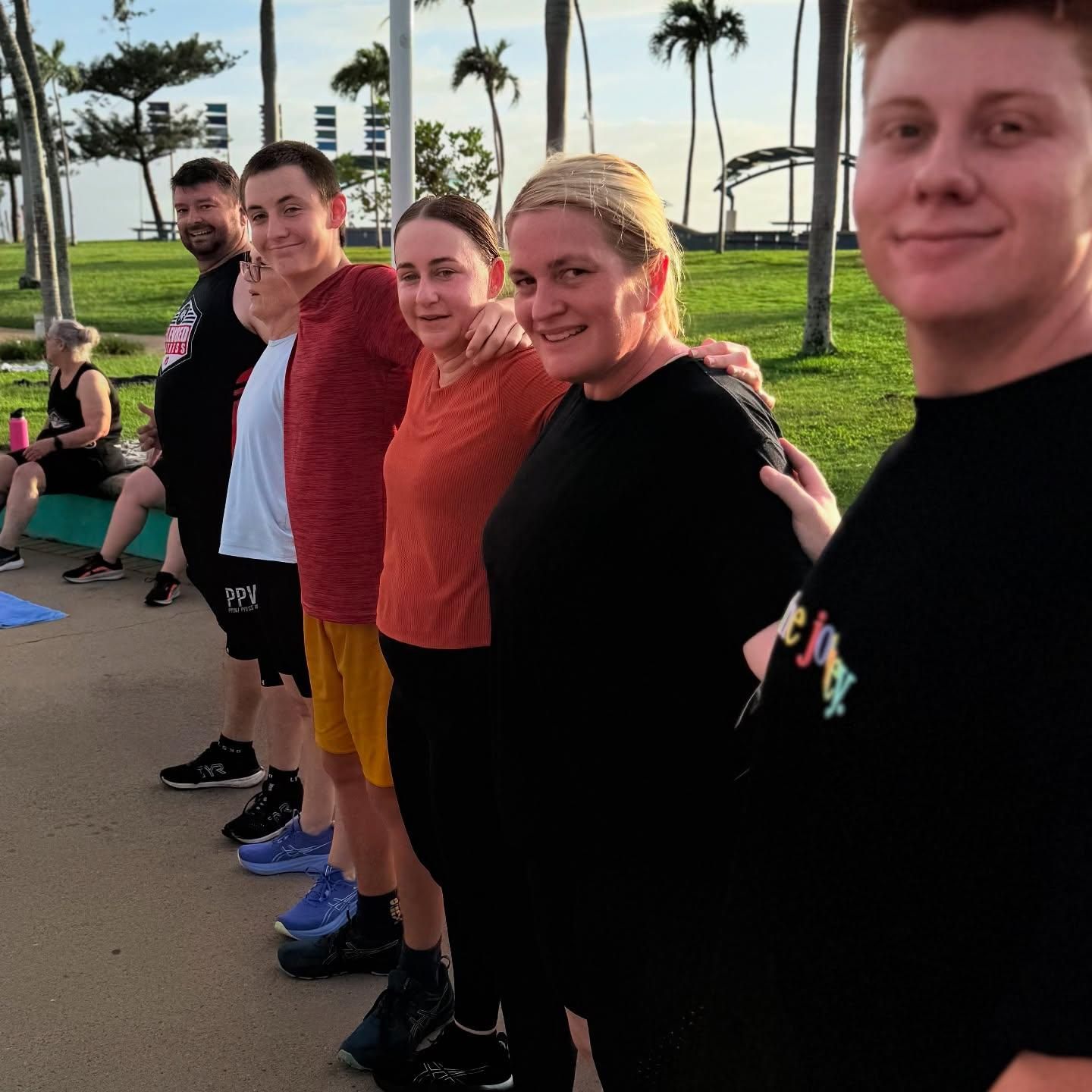 A Group Of People Are Posing For A Picture In A Park — Elev8ed Fitness In Currajong, QLD
