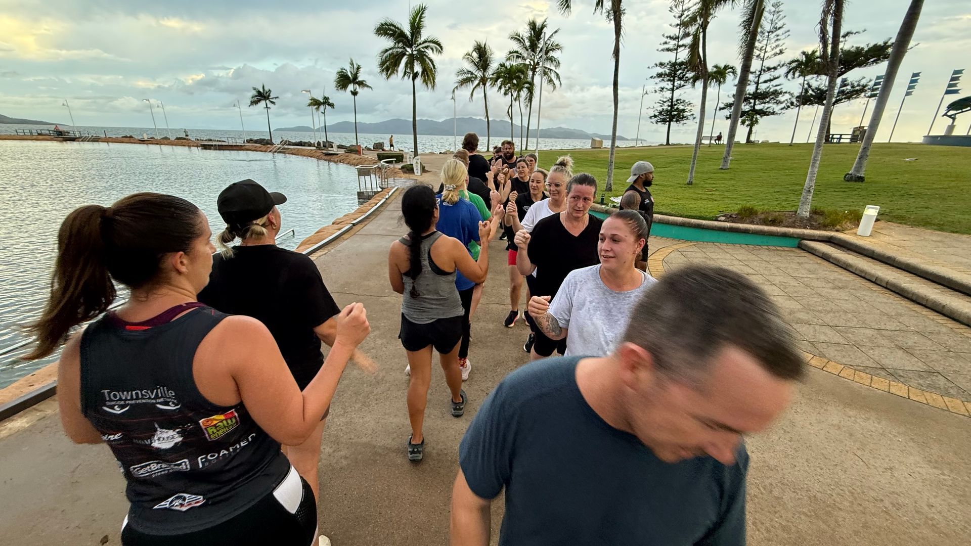 A Group Of People Are Walking in a Circle  Fist Pumping— Elev8ed Fitness In Currajong, QLD