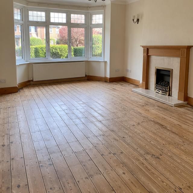 After: the same room with bare floorboards