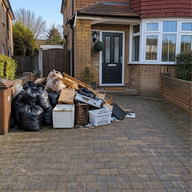Before: mixed household rubbish piled on a driveway