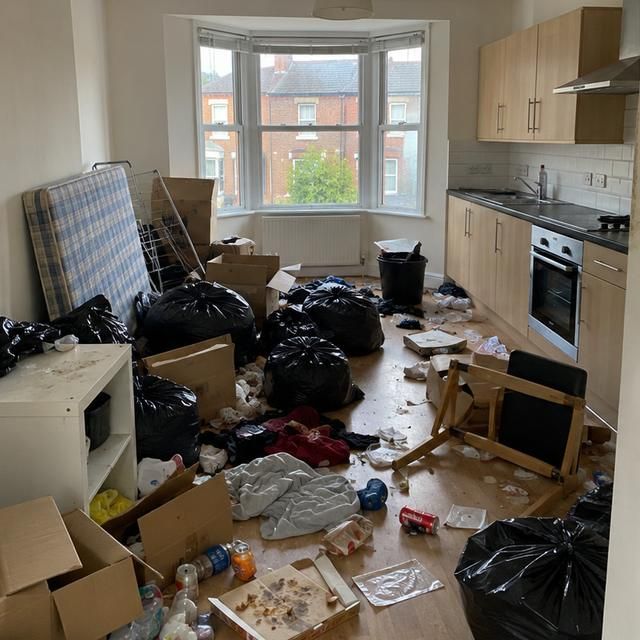 Before: a kitchen diner left full of bags, boxes and rubbish