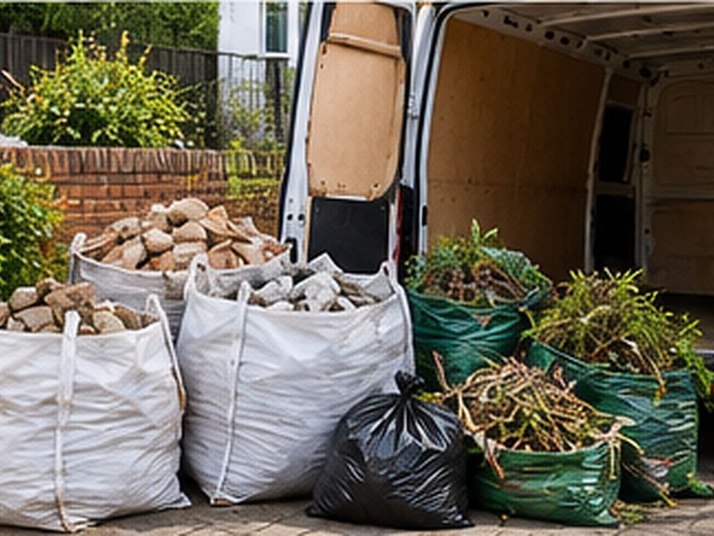 Bulk bags of rubble and green waste beside a van