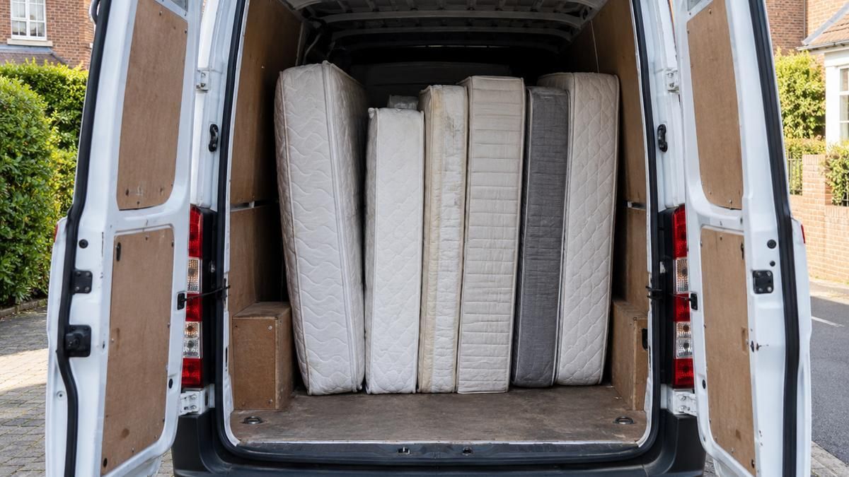 Mattresses stood upright in the back of a van