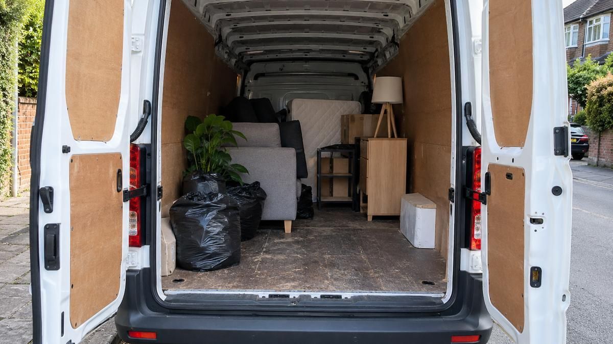 Open van part loaded with furniture, boxes and bags