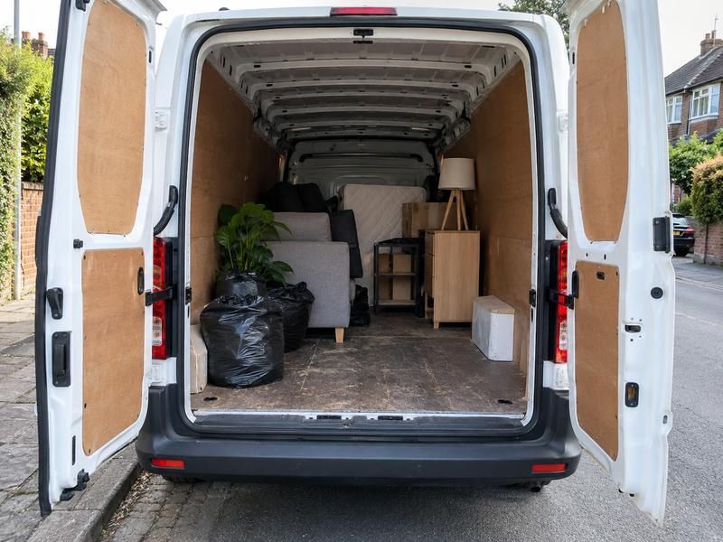 Open van part loaded with furniture, boxes and bags